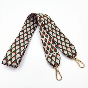 Adjustable wide embroidered bag strap with gold metal lobster clasps and geometric patterns