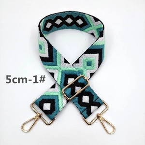 Close-up of 5cm wide ethnic geometric embroidered bag strap with golden metal hooks