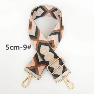 Detail view of 5cm wide colorful geometric woven strap with gold metal buckles