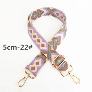 Detail view of 5cm ethnic geometric woven strap with gold metal lobster clasps