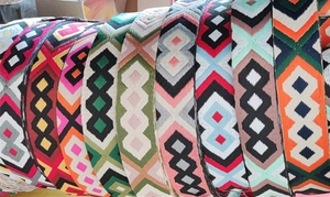 Close-up of ethnic geometric embroidered thick canvas shoulder straps in diverse colors