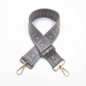 Detail of adjustable ethnic style bag strap with purple and grey jacquard pattern