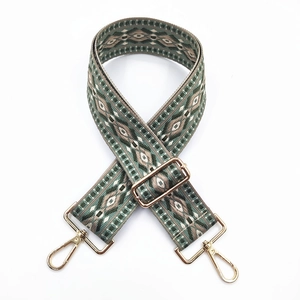 Detailed close-up of ethnic jacquard pattern woven bag strap with golden metal clasps
