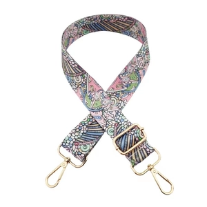 Detail of adjustable bohemian printed wide bag strap with golden metal lobster hooks
