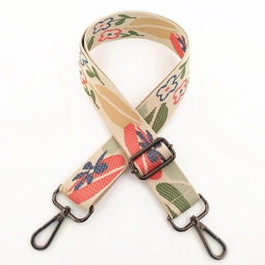 Detail of floral embroidery on wide canvas bag strap with gunmetal lobster clasps
