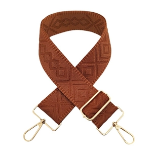 Adjustable brown geometric jacquard purse strap with gold metal hardware and diamond pattern