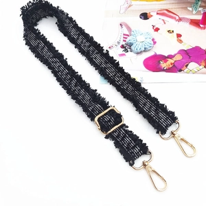 Detailansicht der 3 cm schwarzen Tweed-Taschengurt mit Goldbeschlägen und Fransen