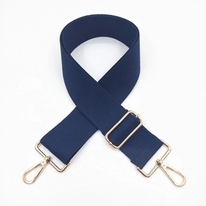 Detail of navy blue adjustable nylon shoulder strap with polished gold metal lobster hooks