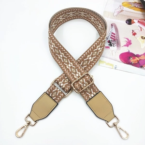 Adjustable woven shoulder strap with geometric ethnic patterns and gold metal hardware