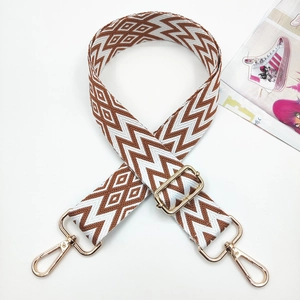 Detail of adjustable geometric woven strap with gold metal hooks for crossbody bags