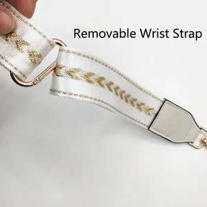 White embroidered detachable phone wrist strap with gold wave pattern and metal spring hook