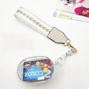 Detail of detachable white woven phone strap with small transparent coin purse and gold clasp