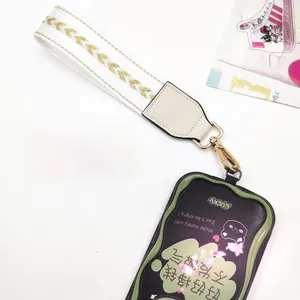 Detail view of woven wrist strap with gold metal lobster clasp and decorative phone pouch