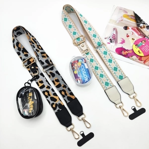 Detail of adjustable crossbody phone straps with detachable leopard and geometric pouches