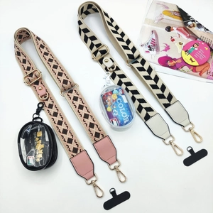 Macro detail of adjustable woven phone straps with detachable coin pouches and metal clips