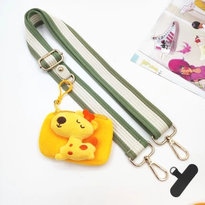 Detail of green and white striped wide strap with gold clips and giraffe plush coin purse