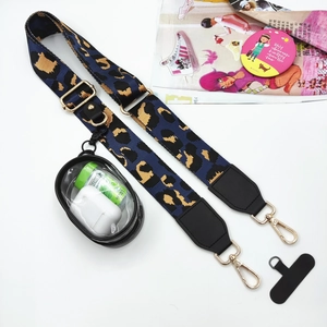Detail of leopard print crossbody phone strap with golden hooks and mini pouch