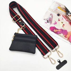 Adjustable black and red striped crossbody strap with small leather pouch and phone patch
