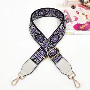 Close-up of bohemian jacquard bag strap with purple floral pattern and golden metal hardware