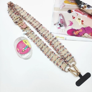 Detail of tweed braided crossbody phone strap with gold hardware and a mini PVC pouch