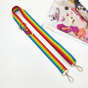 Detailed view of rainbow striped phone strap with gold metal hooks and red leather joints
