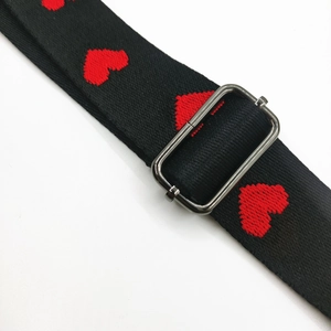 Black fabric crossbody strap with red embroidered hearts and metal adjustment buckle