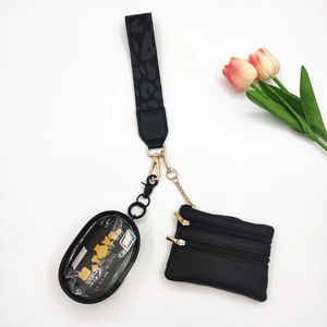 Close-up of leopard pattern strap and triple zipper pouch with gold hardware details
