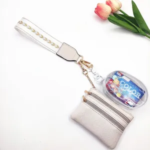 Detail of multi-functional wristlet bag set with cream leather and transparent pouch