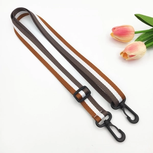Adjustable brown and white striped bag strap with durable black plastic rotating hooks