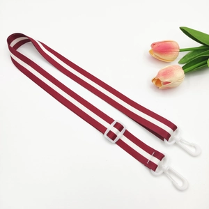 Adjustable red and white striped nylon bag strap with white plastic hooks and buckles