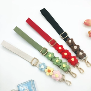 Detailed close-up of colorful crochet flower straps with golden lobster clasps and buckles