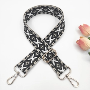 Close-up of adjustable woven shoulder strap with black and white geometric ethnic patterns