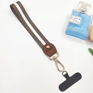 Detail of brown and white striped nylon wrist strap with gold spring buckle and gasket