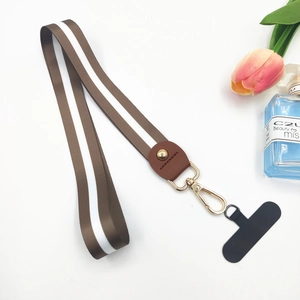 Close-up of brown striped polyester wrist strap with gold hook and faux leather joint