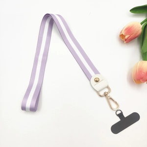 Close-up of purple striped polyester wrist strap with gold hook and phone patch connector