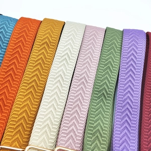 Detailed view of 3.8cm multi-color woven replacement straps with gold metal buckles