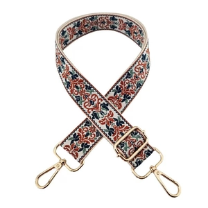 Close-up of ethnic style embroidered replacement bag strap with golden metal swivel hooks