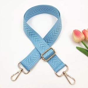 Close-up of light blue 3.8cm woven shoulder strap with gold lobster hooks and V-texture