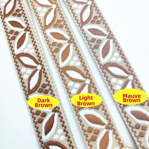 Close-up of embroidered bag straps with leaf patterns in dark and light brown tones