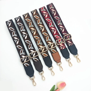 Close-up of colorful ethnic style wide bag straps with golden swivel lobster clasps