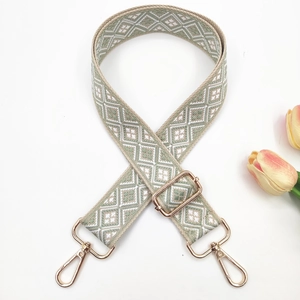 Detail of bohemian geometric 3.8cm wide bag strap with adjustable gold lobster clasps