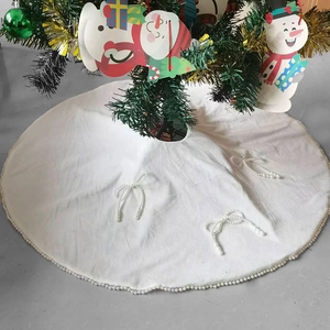 White plush Christmas tree skirt with elegant pearl bow accents and beaded trim borders
