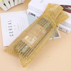 Golden organza drawstring wine bottle bag with sparkling gold dots for Christmas decor