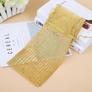 Elegant gold organza drawstring gift bag with sequins and mesh texture for Christmas decor