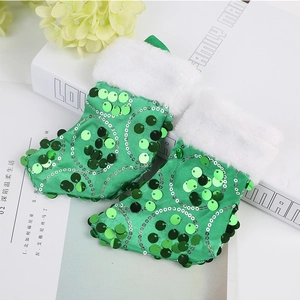 Detail of green sequin Christmas socks with white faux fur trim on a decorative background
