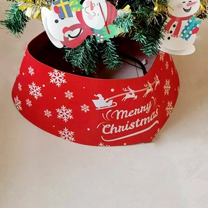 Detail of red Christmas tree collar with white reindeer print and Merry Christmas text