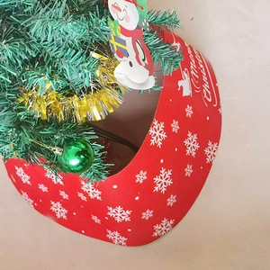 Detail of red Merry Christmas tree collar with white snowflakes and festive ornaments