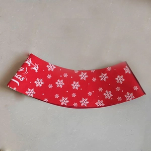 Detail of red Christmas tree skirt with festive white snowflake and reindeer prints