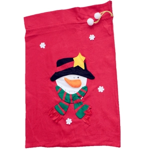 Detail of red fabric Christmas gift bag with snowman collage and gold drawstring