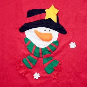 Detail of Christmas gift bag with fabric snowman embroidery on vibrant red felt fabric